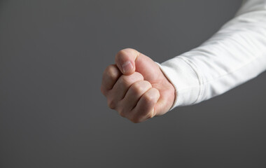 Caucasian angry and aggressive man threatening with fist.
