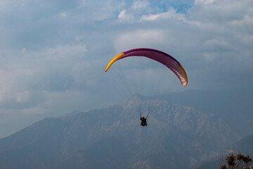 Paragliding over the clouds sunset view at Bir Billing Himachal Pradesh India. Clouds in the sky,