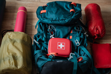 A sturdy backpack that contains a comprehensive first aid kit is currently placed on a polished...