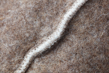 A fuzzy gray and white object with a white line running through it