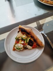 Delicious slice of pizza with a crispy crust, gooey melted cheese, and flavorful toppings. Perfect for a quick snack, party treat, or satisfying meal. Irresistibly cheesy and full of flavor!