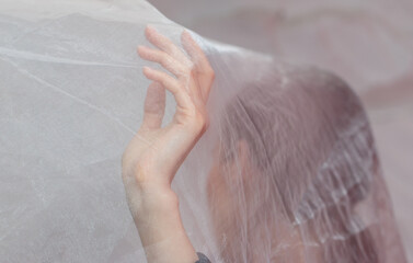 A woman's hand is covered by a white cloth