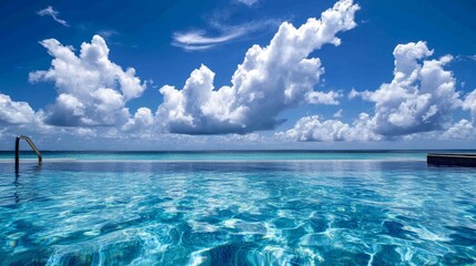 Obraz premium Stunning swimming pool with clear blue water and fluffy clouds in half underwater view