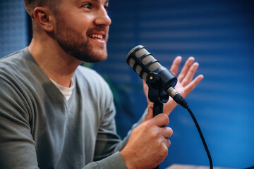 Man with microphone in the studio, conception of podcast