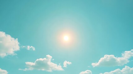 Bright Sun Shining in a Blue Sky with Fluffy Clouds