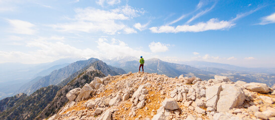 girl in the mountains. a climber walks along a rocky ridge. girl climbs the mountains....