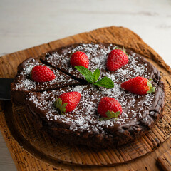Delicious sweet cheesecake with chocolate and fresh strawberries.