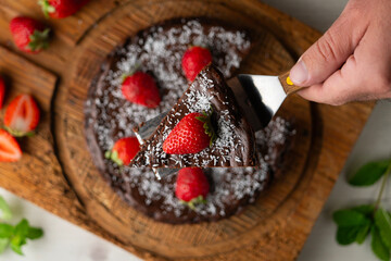 Delicious sweet cheesecake with chocolate and fresh strawberries.