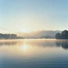 Obraz premium Serene Dawn Landscape: Tranquil Lake with Mist and Golden Sunlight - A Captivating Nature Scene