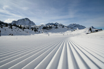 A freshly groomed ski slope in the Warth ski area in Lechtal with perfectly visible grooves in the...
