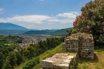 A view from the fortified walls of the 13th century Berat Castle in Albania. View over the Lagja 30 Vjetori district of Berat with a large oleander tree on the right. A 