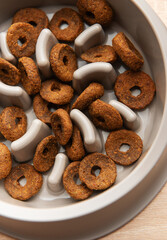 Dry dog food in slow feeder bowl preventing gulping and improving digestion
