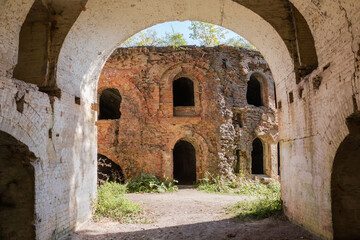 Fototapeta premium Ruined defensive buildings of brick on old fortress territory