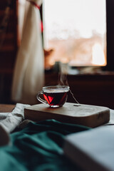 Glass cup of black tea with steam evening rest	