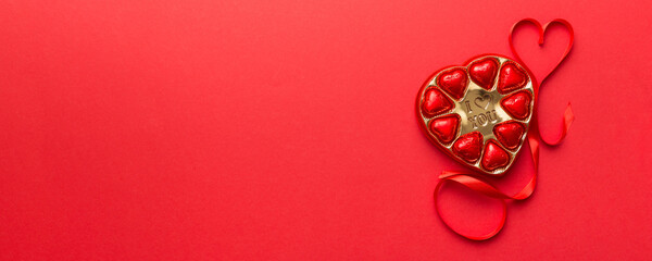 Delicious chocolate pralines in red box for Valentine's Day. Heart shaped box of chocolates top...