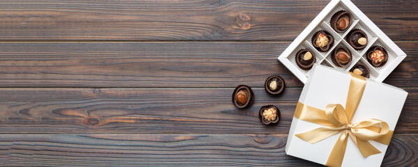White box with chocolates candies and golden tape. top view with copy space
