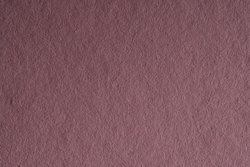 Macro close-up of dark mauve paper texture filling the frame