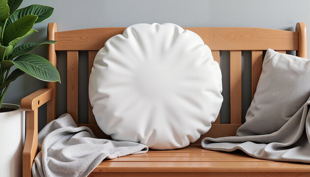 A cozy round pillow mockup displayed on a wooden bench, accompanied by a soft throw blanket and surrounded by natural greenery. Perfect for showcasing fabric patterns, pillow designs, or home decor