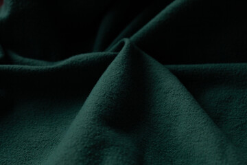 Deep green fabric with rippling texture, creates a sense of depth and tactile interest. Cozy,...