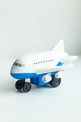 Blue and white toy airplane sits ready for takeoff. A child's imagination soars as the toy prepares for adventures and imaginary journeys.