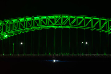 illuminated bridge on the sea in the night