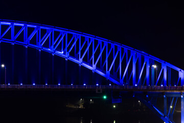 illuminated bridge on the sea in the night