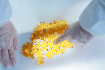 Quality control of omega 3 capsules in medical production by worker