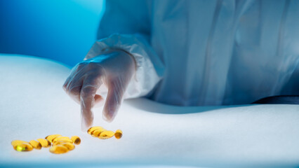 Medical worker inspects quality of omega 3 capsules in laboratory