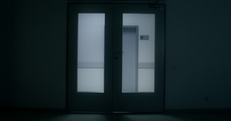 Medical staff are running down the hospital corridor carrying a patient on a gurney