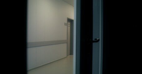 Medical staff are running down the hospital corridor carrying a patient on a gurney