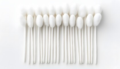 Row of clean white cotton swabs on a white background