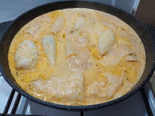 Preparation of russian dish golubtsi - meatballs in cabbage in a frying pan on the stove