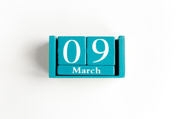 9 march. Blue cube calendar with month and date isolated on white
