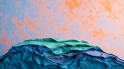 Obraz premium Cool-toned papier-m,ch, layers with textured gradient backdrop, artistic backdrop