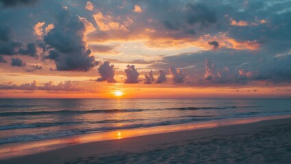 Fototapeta premium Beach sunset with colorful clouds and reflections on water during dusk on a calm sea landscape