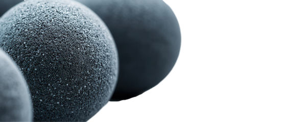 Black textured spheres transparent background close-up abstract art studio setting macro viewpoint
