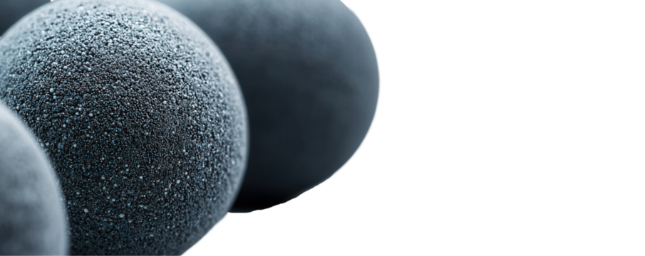 Black textured spheres transparent background close-up abstract art studio setting macro viewpoint