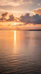 Obraz premium A panoramic view of the Gulf of America during the golden hour, with soft, warm sunlight reflecting off the water