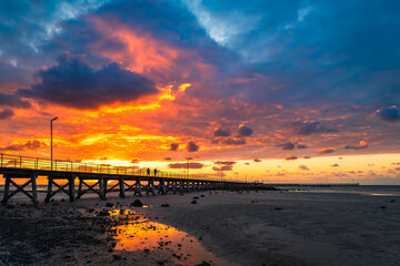 Dramatic sunset above Moonta Bay Jetty with people walking along,  Copper Coast, Yorke Peninsula,...