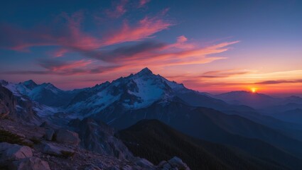 Obraz premium Mountain landscape at sunset with dramatic clouds and varying shades of blue and purple in the sky over rugged terrain and snow-capped peaks