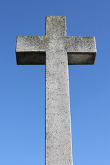 A stone cross on a blue sky