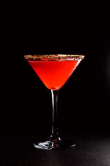 Red Aperol Orange drink in a martini glass with a piece of dried orange. A refreshing cold drink for summer parties. Long alcoholic drink for a bar cocktail card. Party concept for girls.