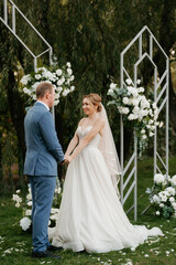 wedding ceremony of the newlyweds on the glade