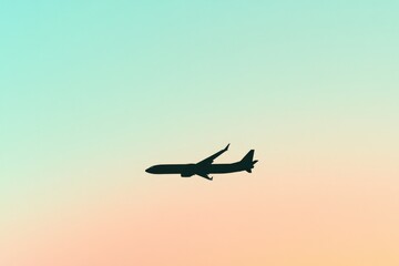 Silhouette of airplane gliding through pastel sky at sunset, evo