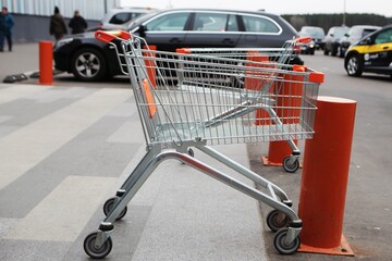 Shopping cart in the parking lot near the supermarket © evgen