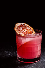 Alcoholic cocktail Aperol syringe. Refreshing cocktail drink with orange and mint on a dark blue textured background.