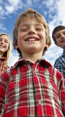 Kids laughing outdoors, happy siblings, cloudy sky background, family portrait, possible use in advertising