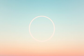 Soft gradient sky showcases delicate circular shape, evoking tra