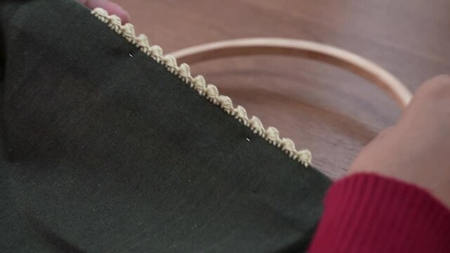 Loosening a Hoop to Reveal a Hand-Stitched Design
