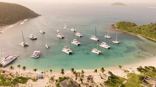Aerial view of Mayreau in St. Vincent and the Grenadines during sunset with catamarans in the bay